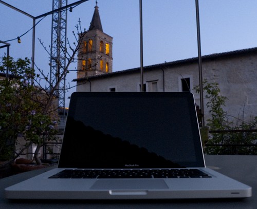 The Mac Book with the church tower of Bevagna on the background.